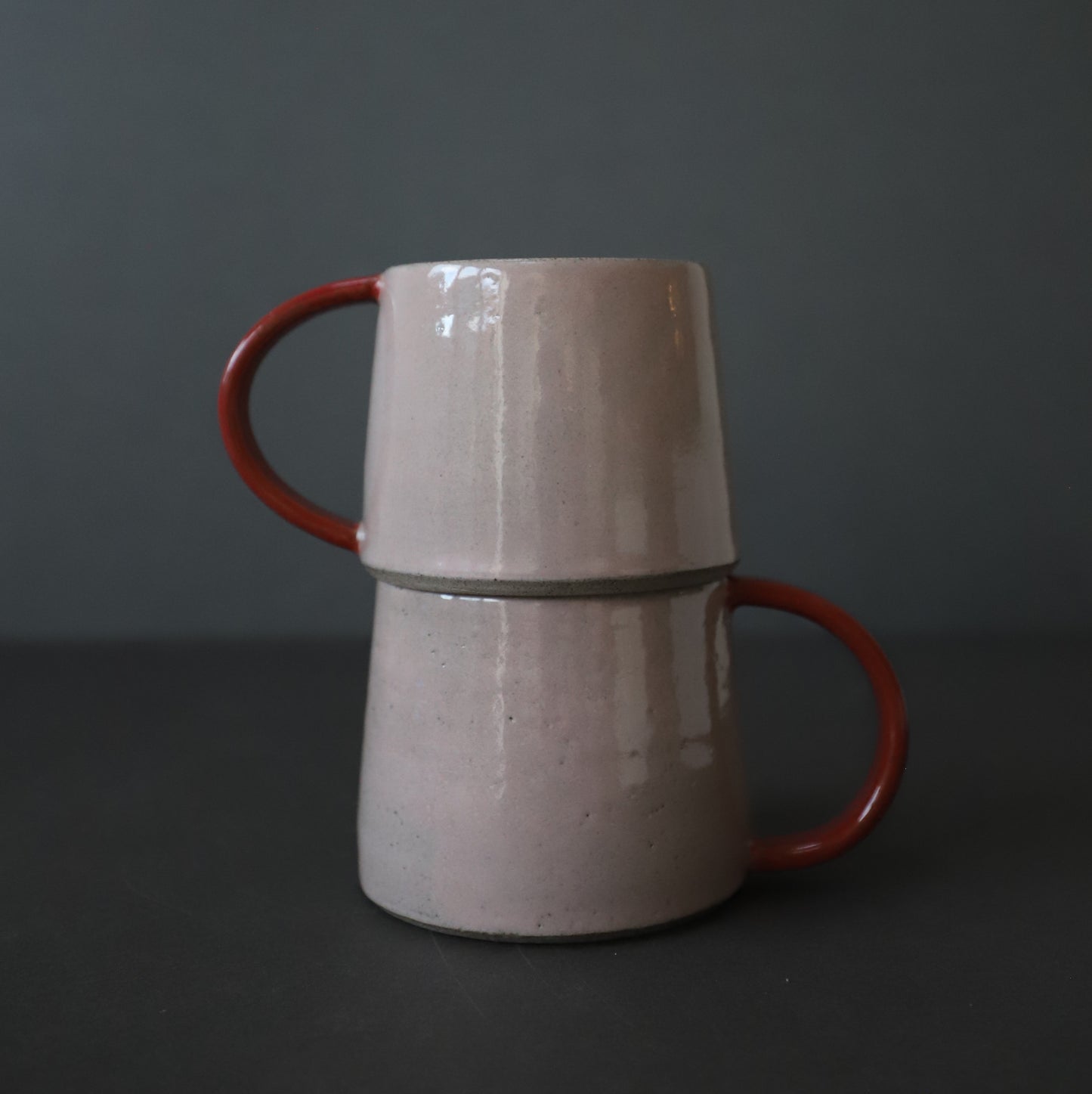 Stoneware cup in blush pink and dark red colour block