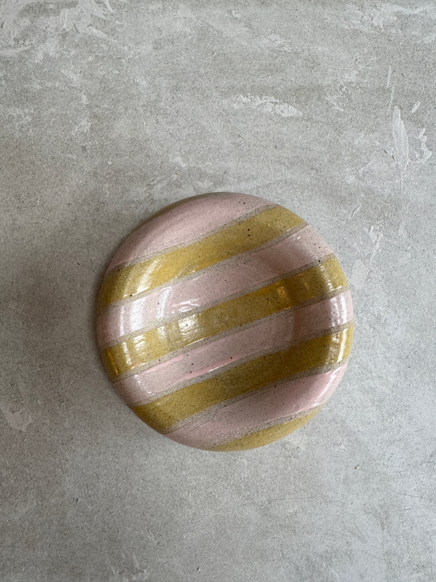 Hollow rimmed dish with pink and mustard stripes